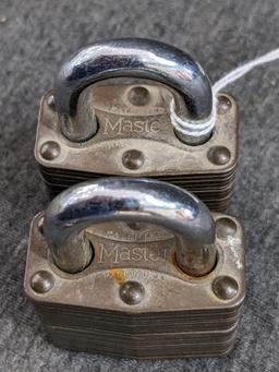 Pair of No. 4 brass Marine padlocks by Master Lock are keyed alike. About 2-1/4" long.