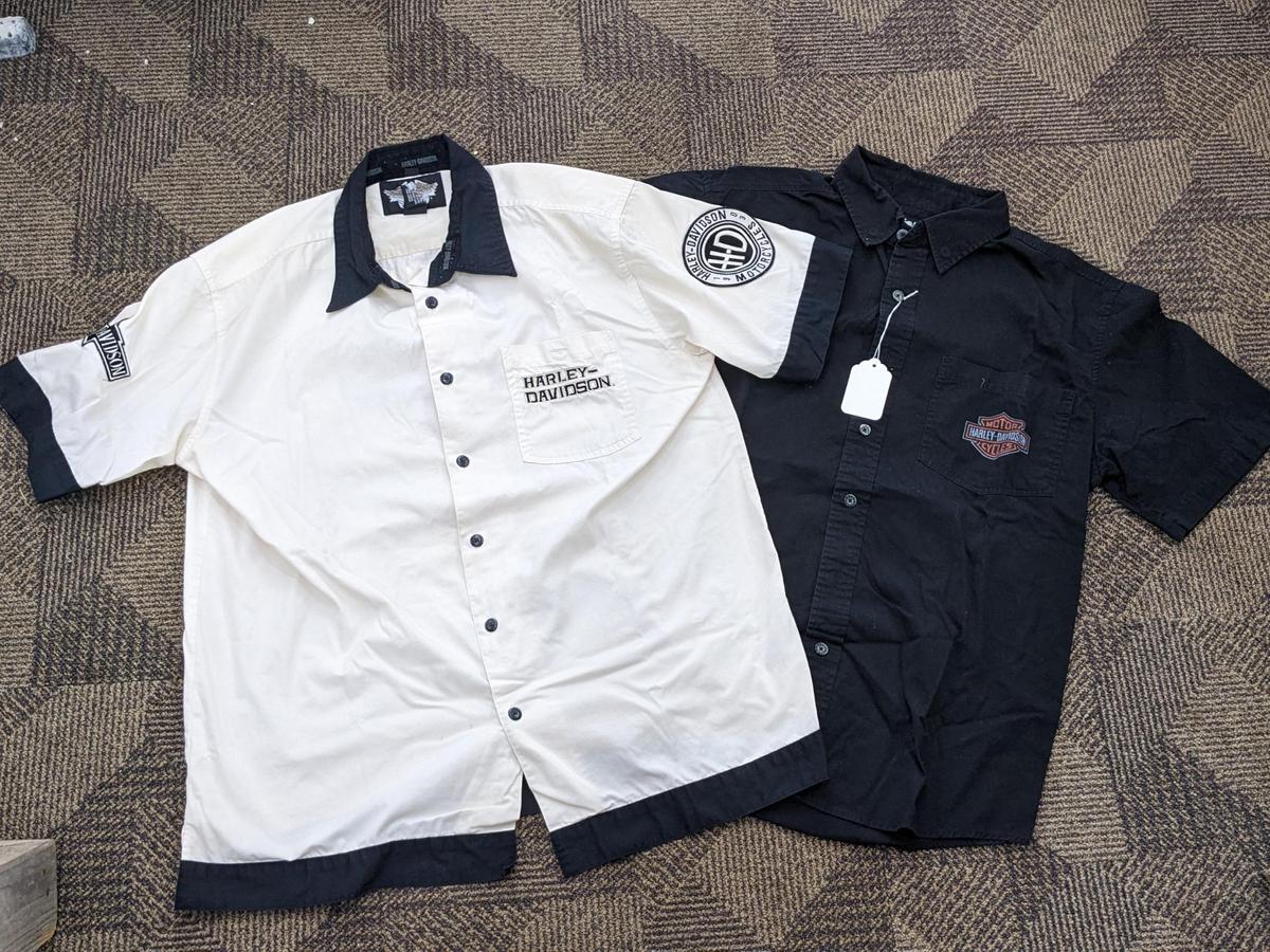 Two Harley-Davidson button-up shirts. Both appear in good condition and are sizes medium and large.