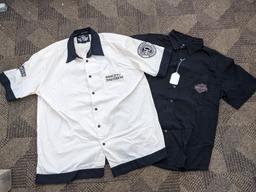 Two Harley-Davidson button-up shirts. Both appear in good condition and are sizes medium and large.
