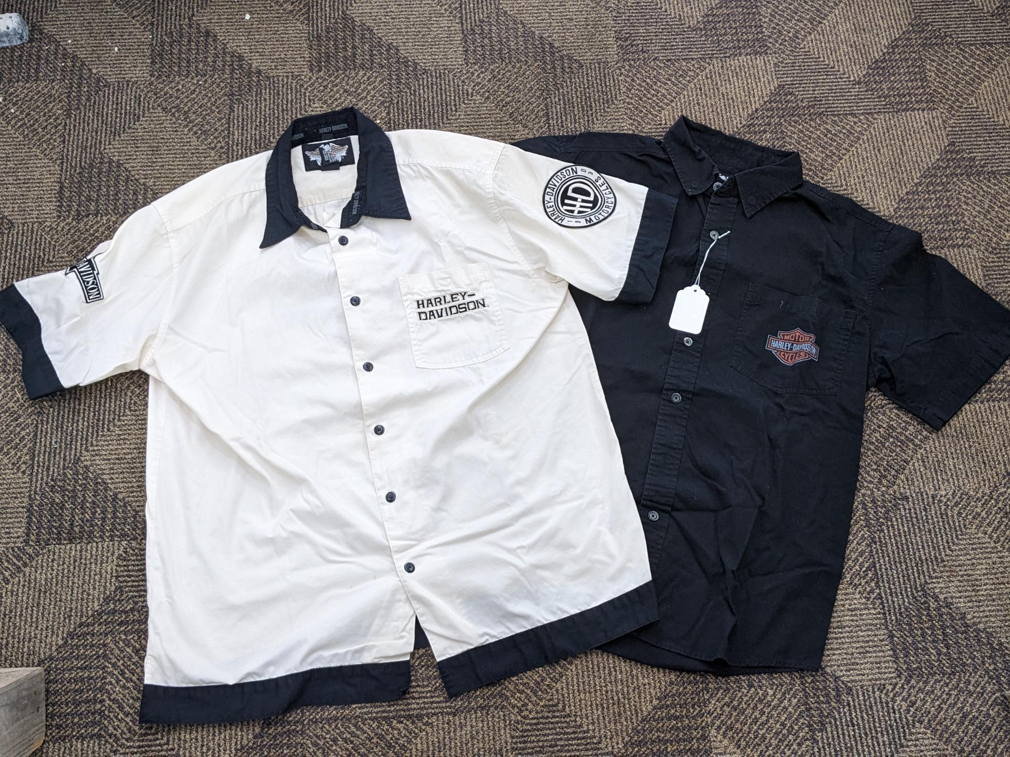 Two Harley-Davidson button-up shirts. Both appear in good condition and are sizes medium and large.