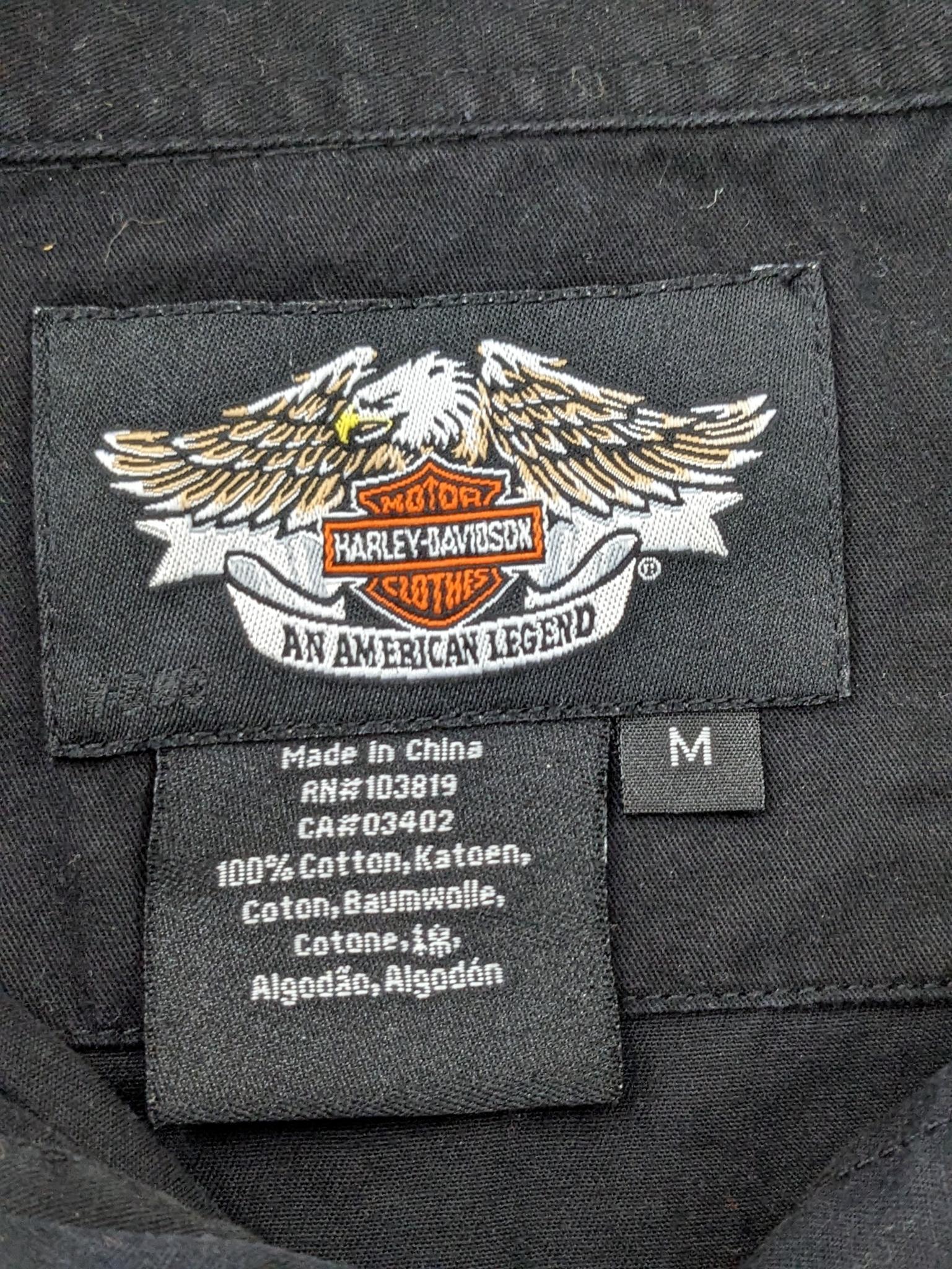 Two Harley-Davidson button-up shirts. Both appear in good condition and are sizes medium and large.