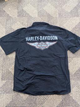 Two Harley-Davidson button-up shirts. Both appear in good condition and are sizes medium and large.