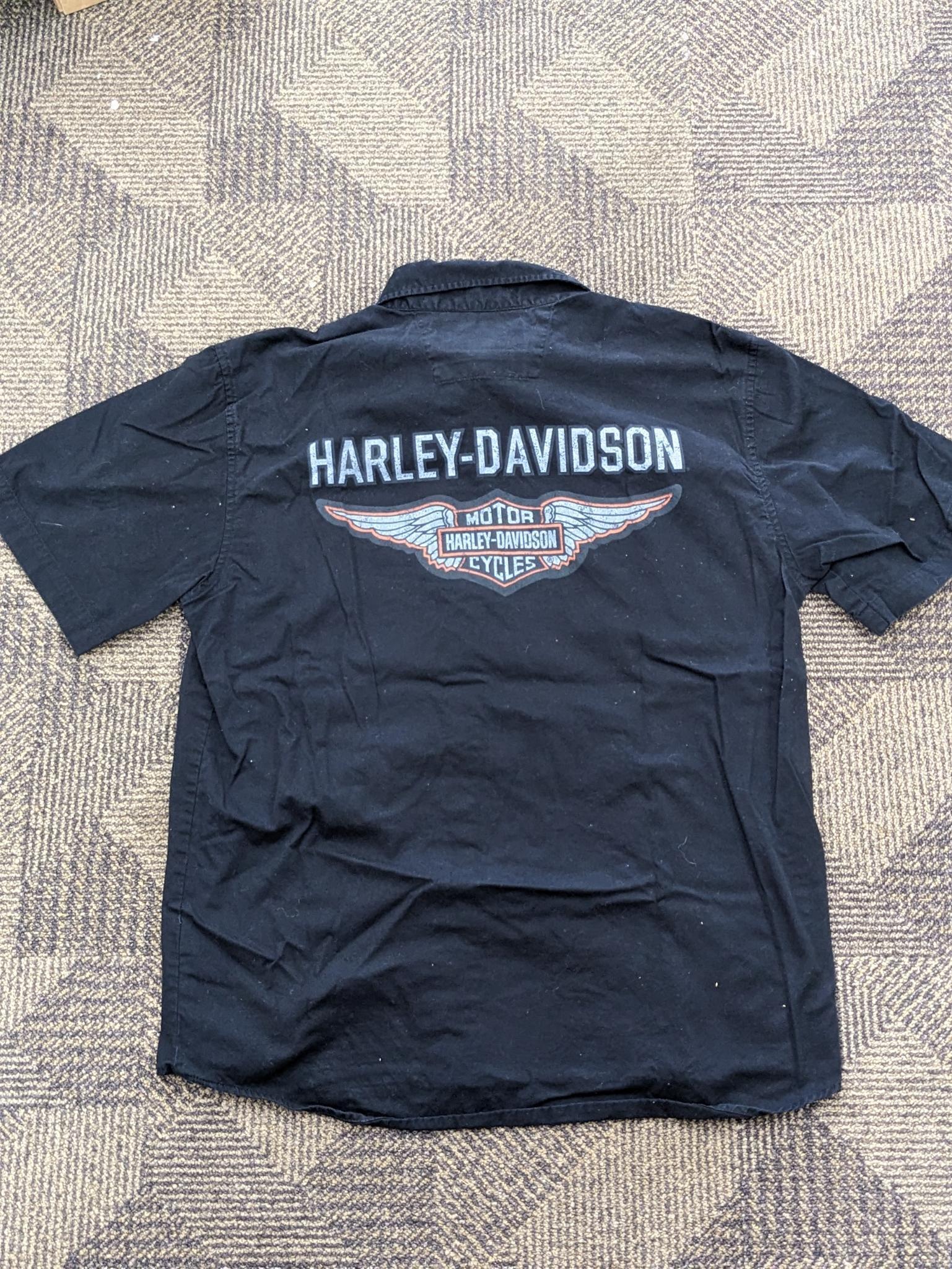 Two Harley-Davidson button-up shirts. Both appear in good condition and are sizes medium and large.