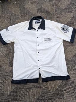 Two Harley-Davidson button-up shirts. Both appear in good condition and are sizes medium and large.