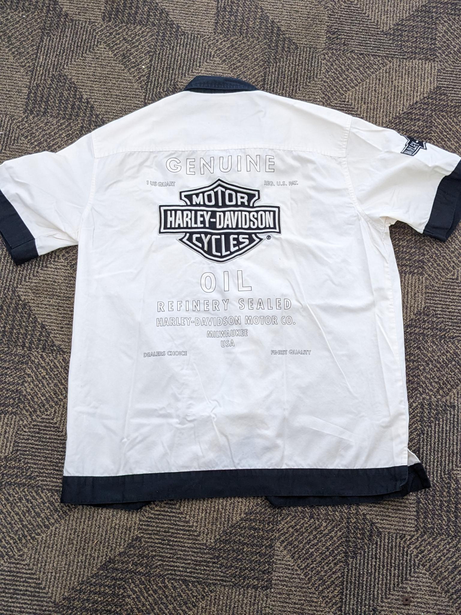 Two Harley-Davidson button-up shirts. Both appear in good condition and are sizes medium and large.