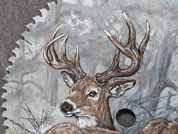 Painted saw blade are with two deer and painted by Carol Ahrens in 2013.
