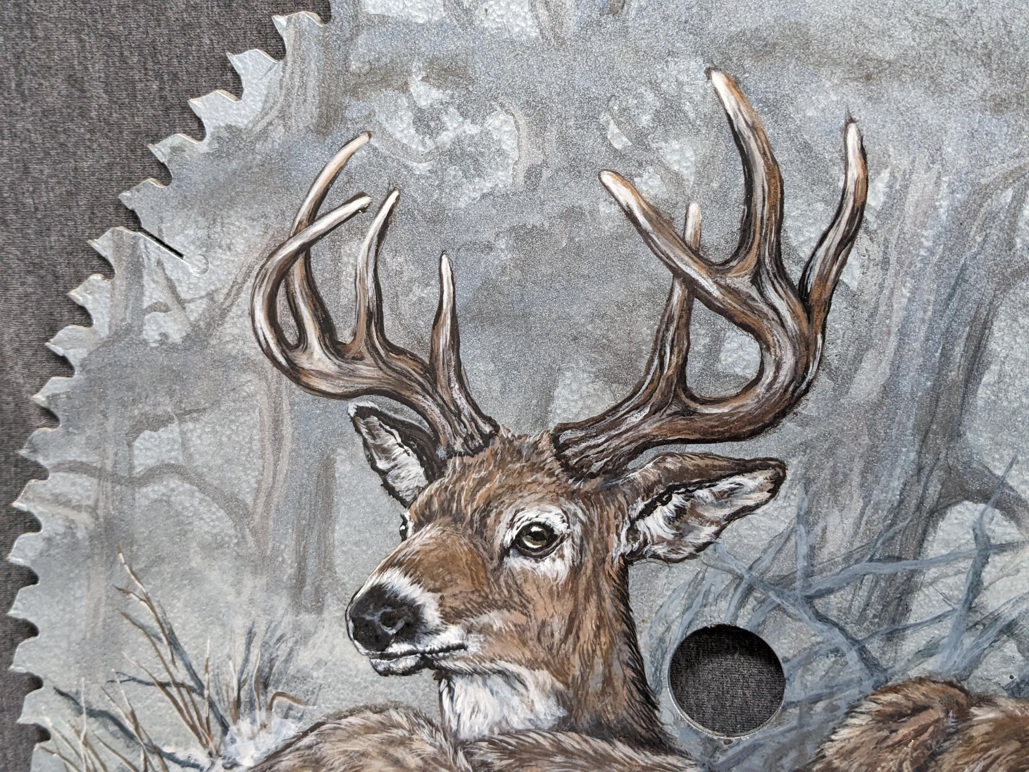 Painted saw blade are with two deer and painted by Carol Ahrens in 2013.