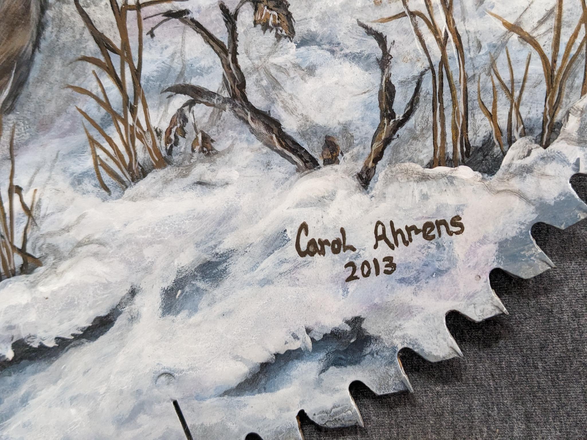 Painted saw blade are with two deer and painted by Carol Ahrens in 2013.