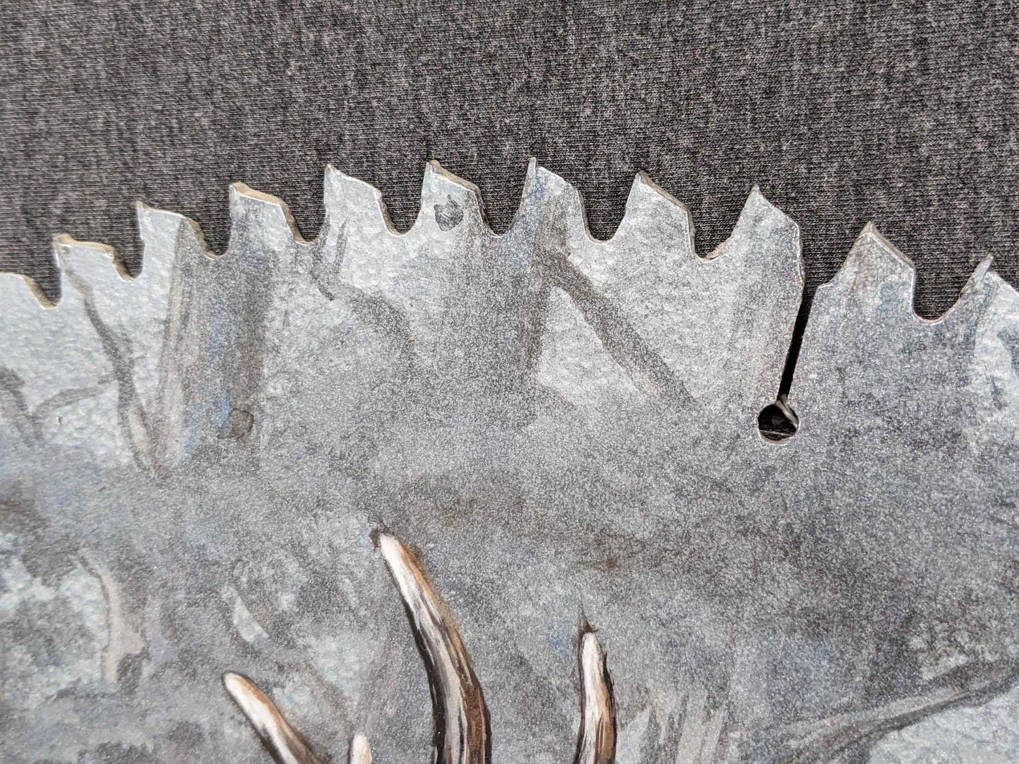 Painted saw blade are with two deer and painted by Carol Ahrens in 2013.