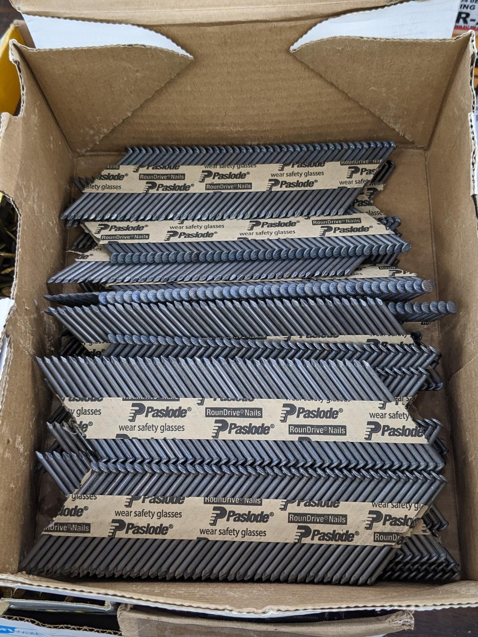 Partial box of Paslode 30 degree smooth shank nails, are 2-3/8" long.