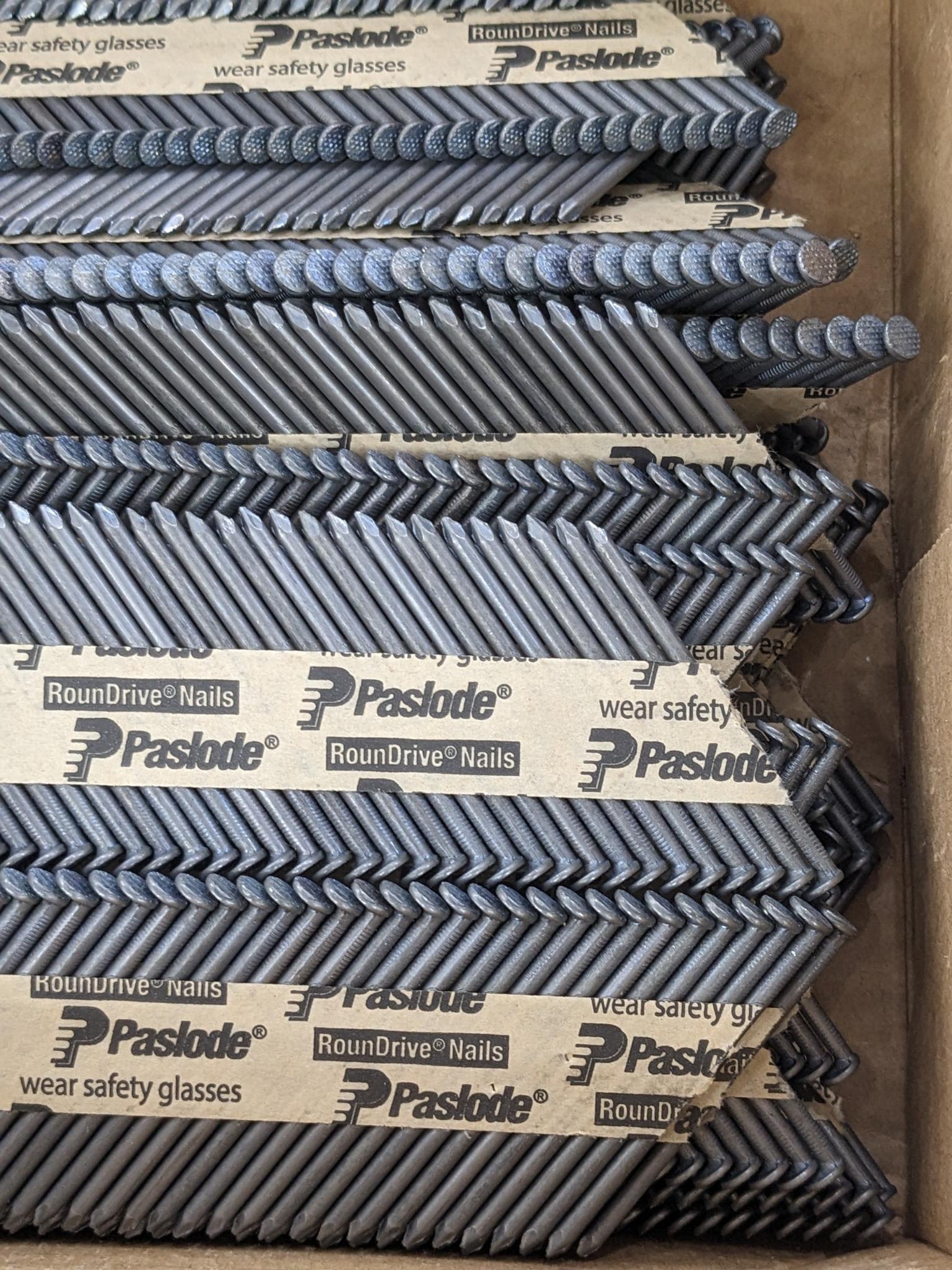 Partial box of Paslode 30 degree smooth shank nails, are 2-3/8" long.