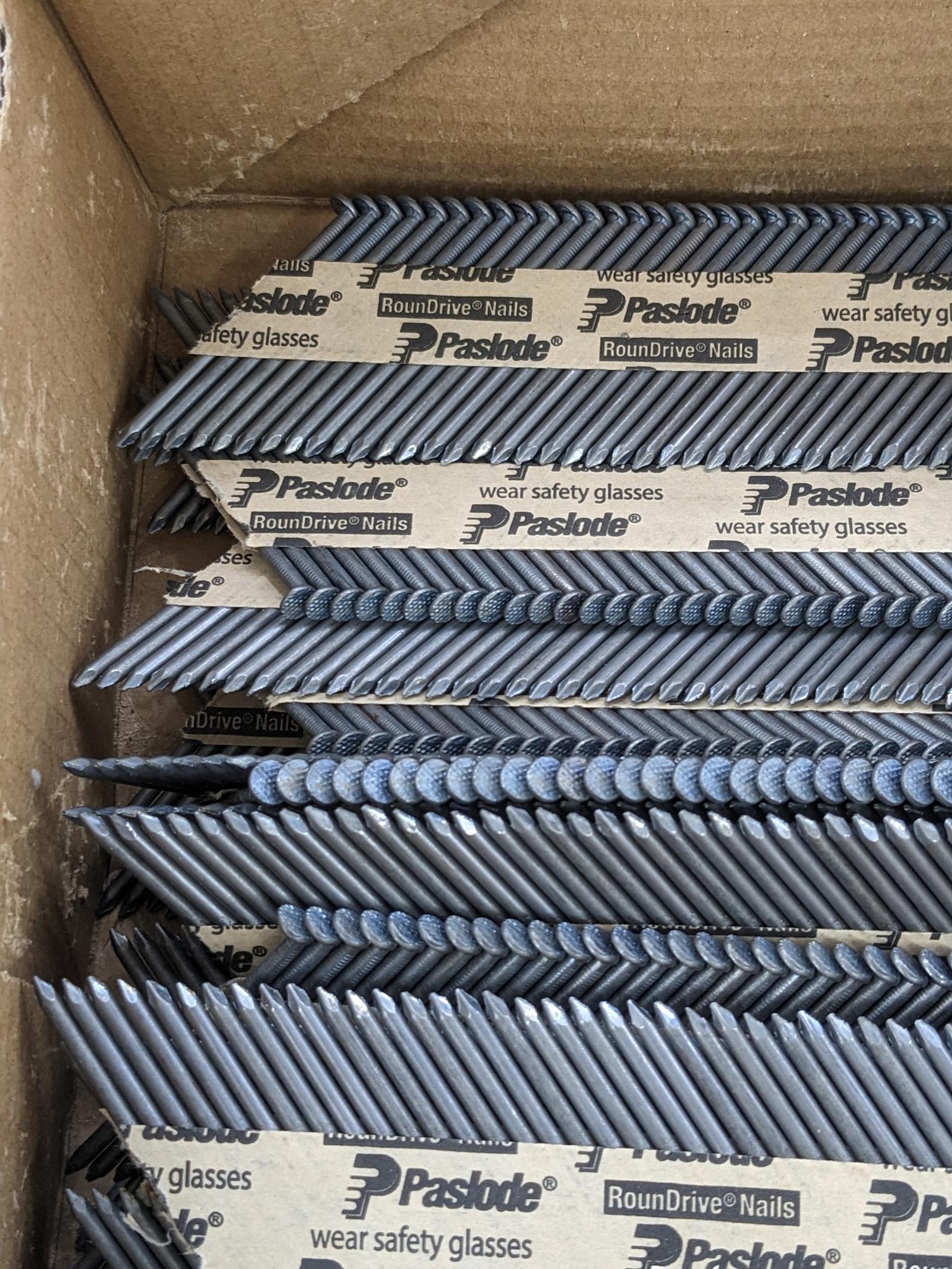 Partial box of Paslode 30 degree smooth shank nails, are 2-3/8" long.