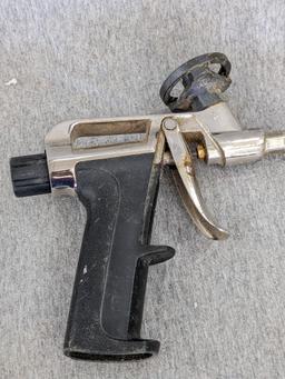 Three foam spraying guns, one labeled Great Stuff pro series 13, comes with four extra tips.