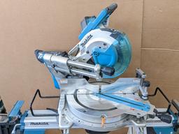 Makita sliding compound miter saw w/ laser guide, angle up to 60 degrees. Has dust bag, and comes on