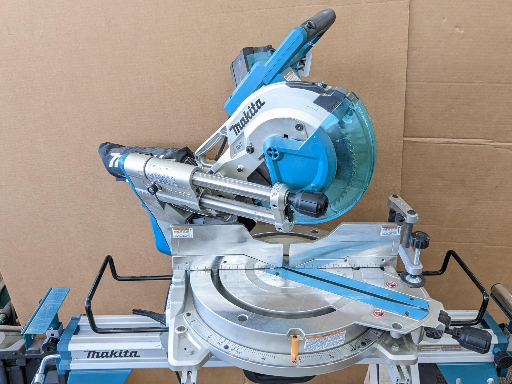 Makita sliding compound miter saw w/ laser guide, angle up to 60 degrees. Has dust bag, and comes on
