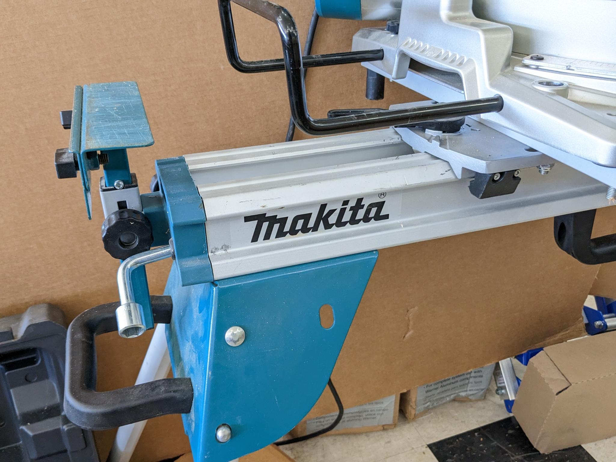 Makita sliding compound miter saw w/ laser guide, angle up to 60 degrees. Has dust bag, and comes on