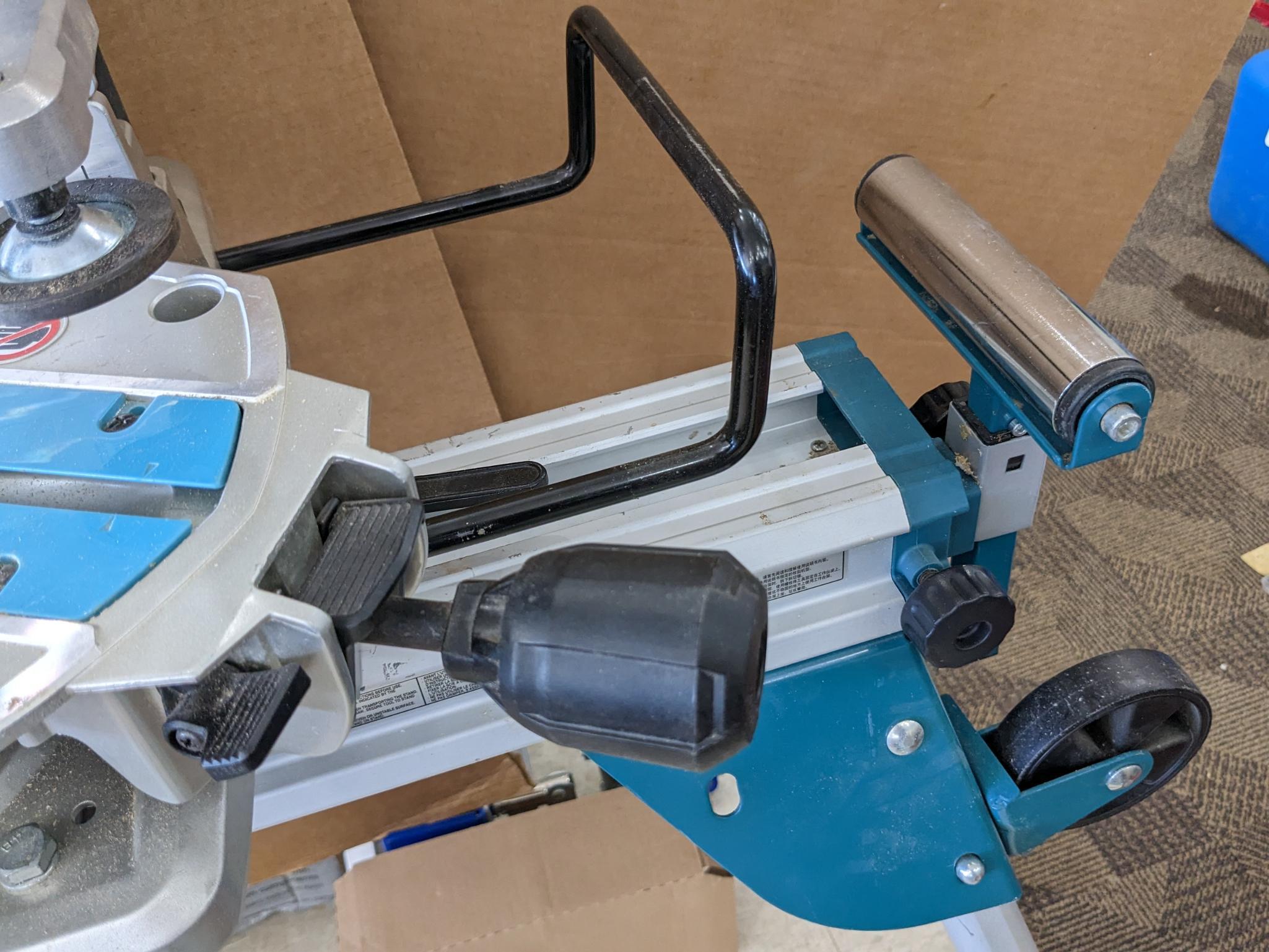 Makita sliding compound miter saw w/ laser guide, angle up to 60 degrees. Has dust bag, and comes on