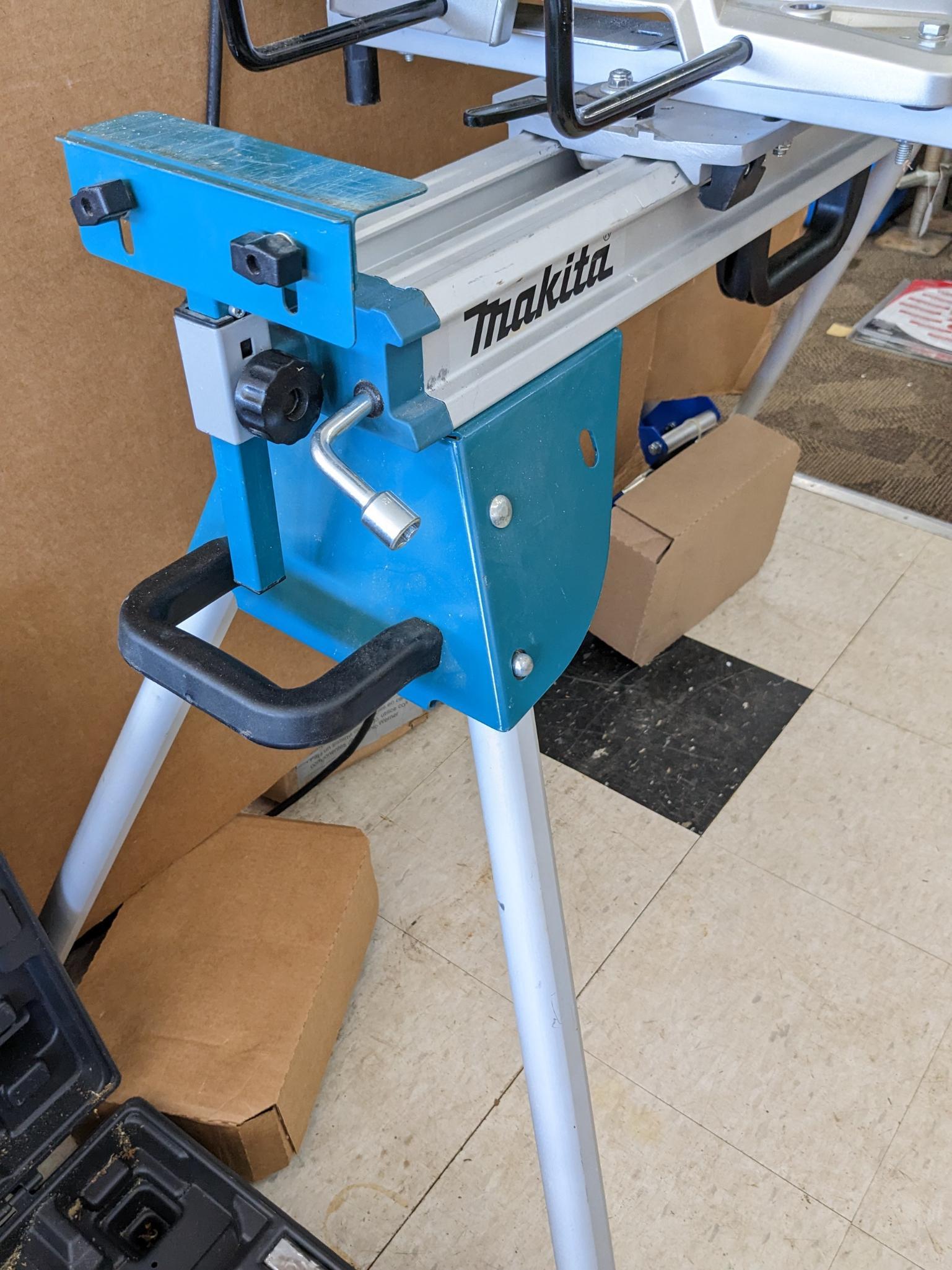 Makita sliding compound miter saw w/ laser guide, angle up to 60 degrees. Has dust bag, and comes on