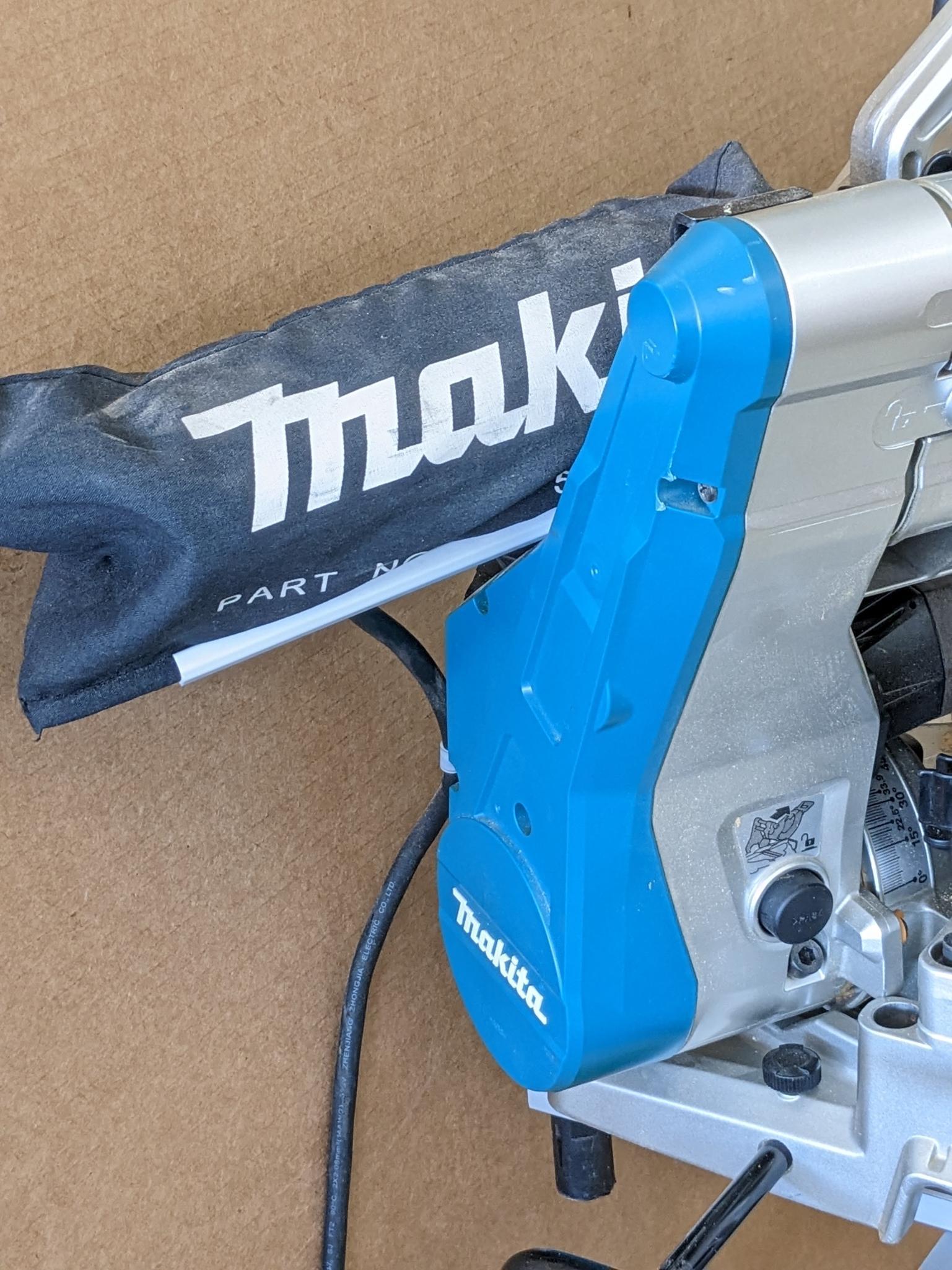 Makita sliding compound miter saw w/ laser guide, angle up to 60 degrees. Has dust bag, and comes on