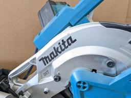 Makita sliding compound miter saw w/ laser guide, angle up to 60 degrees. Has dust bag, and comes on