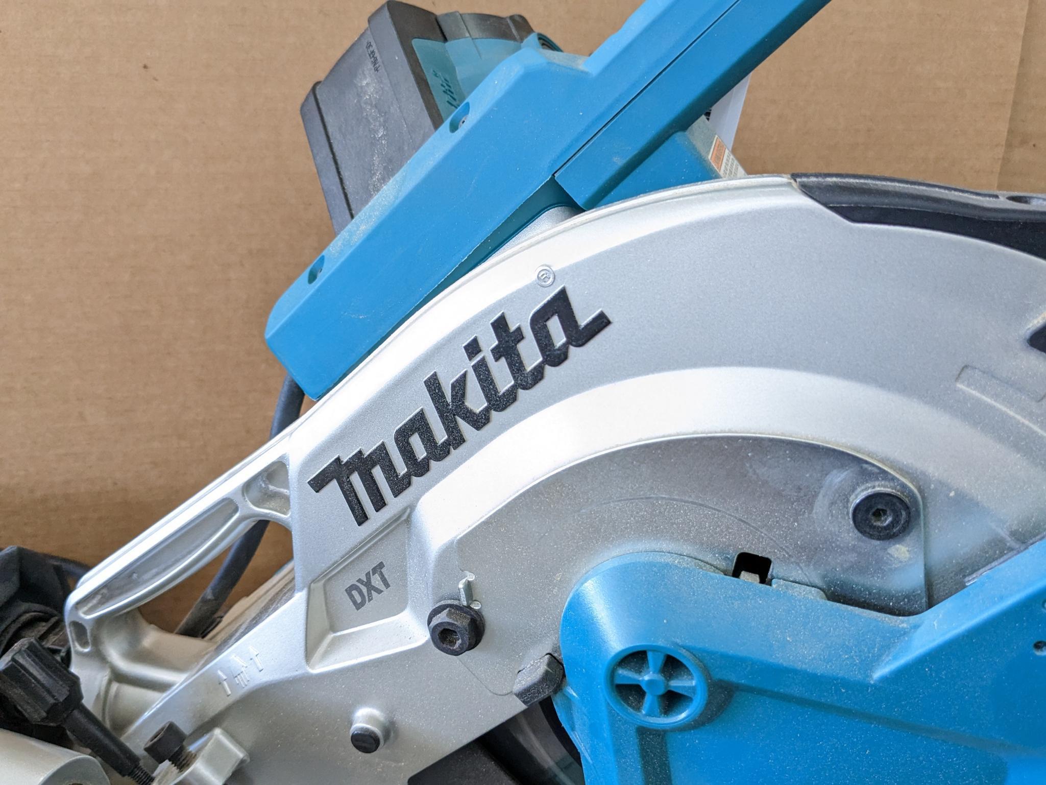 Makita sliding compound miter saw w/ laser guide, angle up to 60 degrees. Has dust bag, and comes on