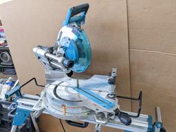 Makita sliding compound miter saw w/ laser guide, angle up to 60 degrees. Has dust bag, and comes on