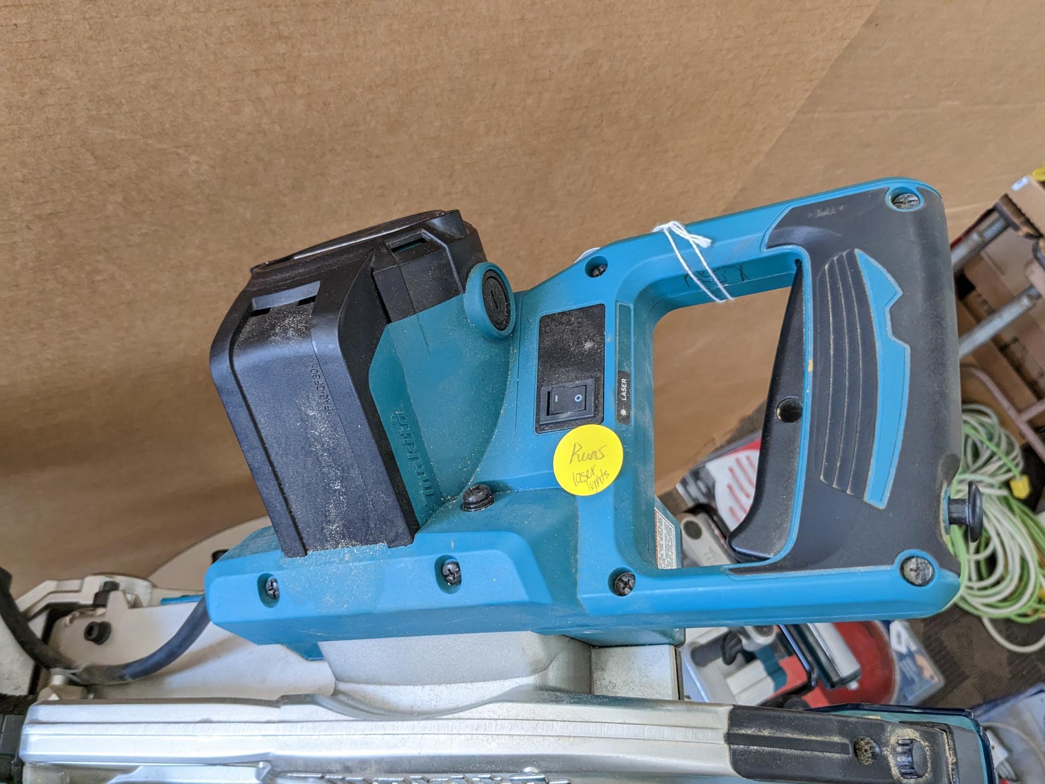 Makita sliding compound miter saw w/ laser guide, angle up to 60 degrees. Has dust bag, and comes on