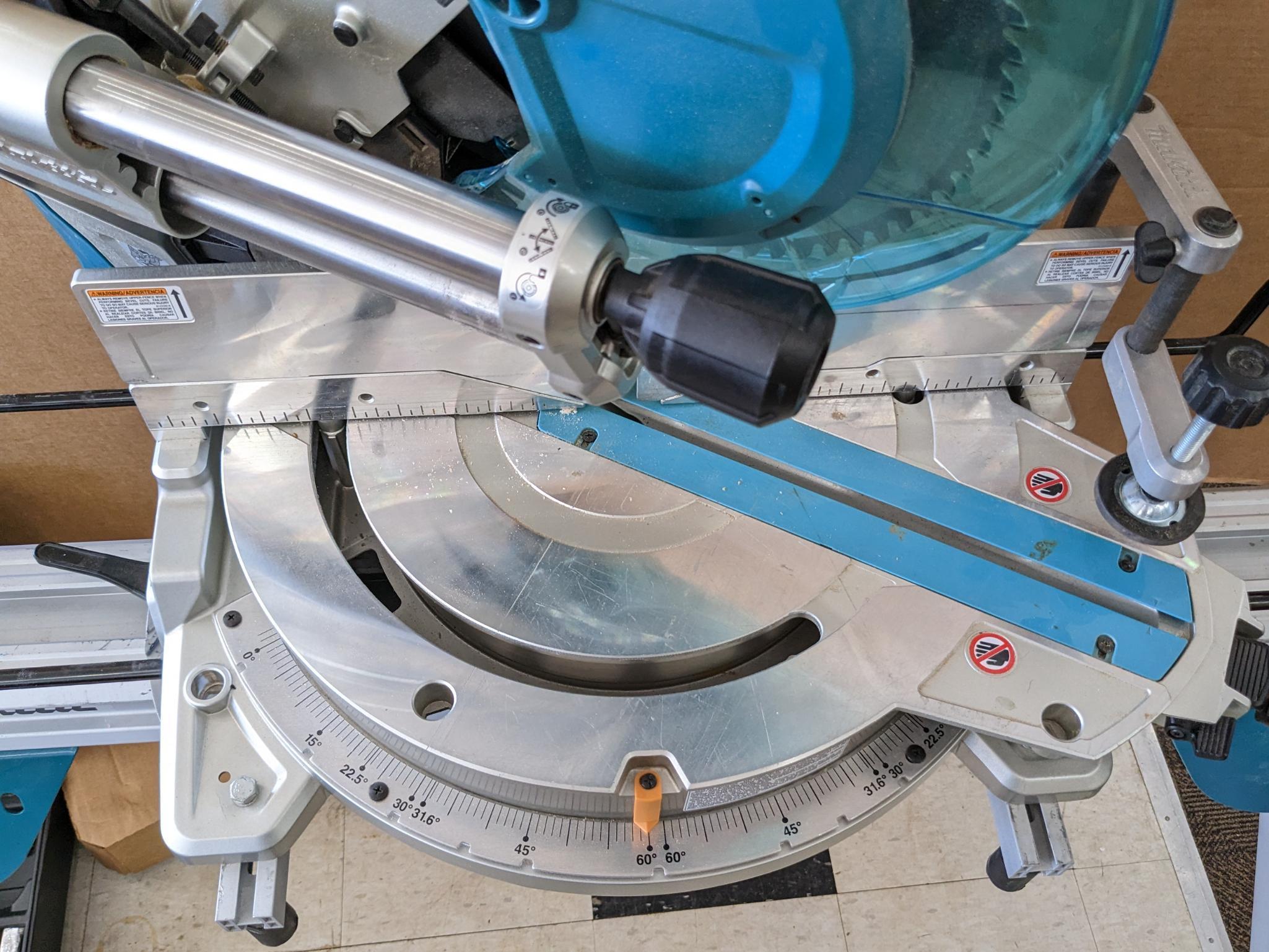 Makita sliding compound miter saw w/ laser guide, angle up to 60 degrees. Has dust bag, and comes on