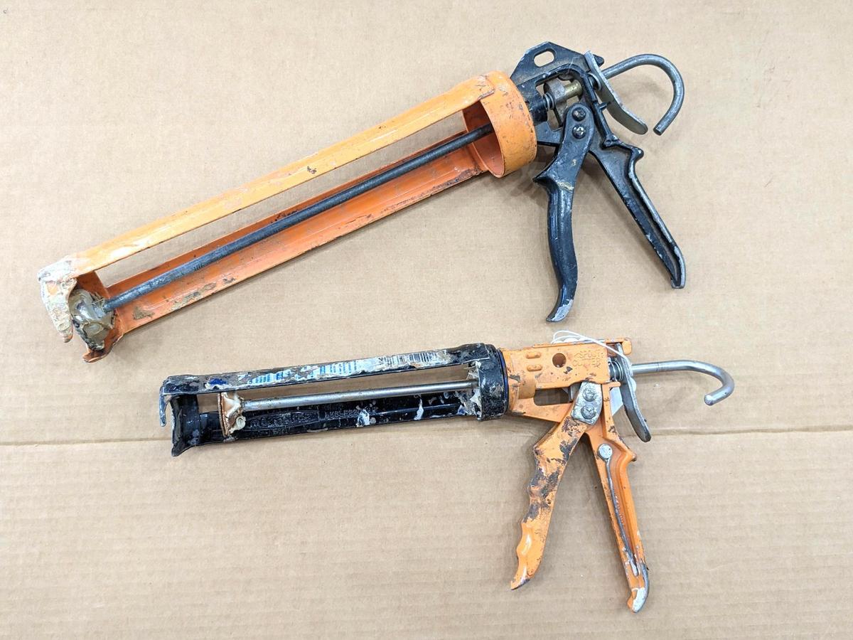 Two swiveling case caulk guns, one takes regular size tubes, other takes large. Both appear in good