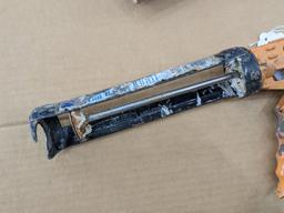Two swiveling case caulk guns, one takes regular size tubes, other takes large. Both appear in good