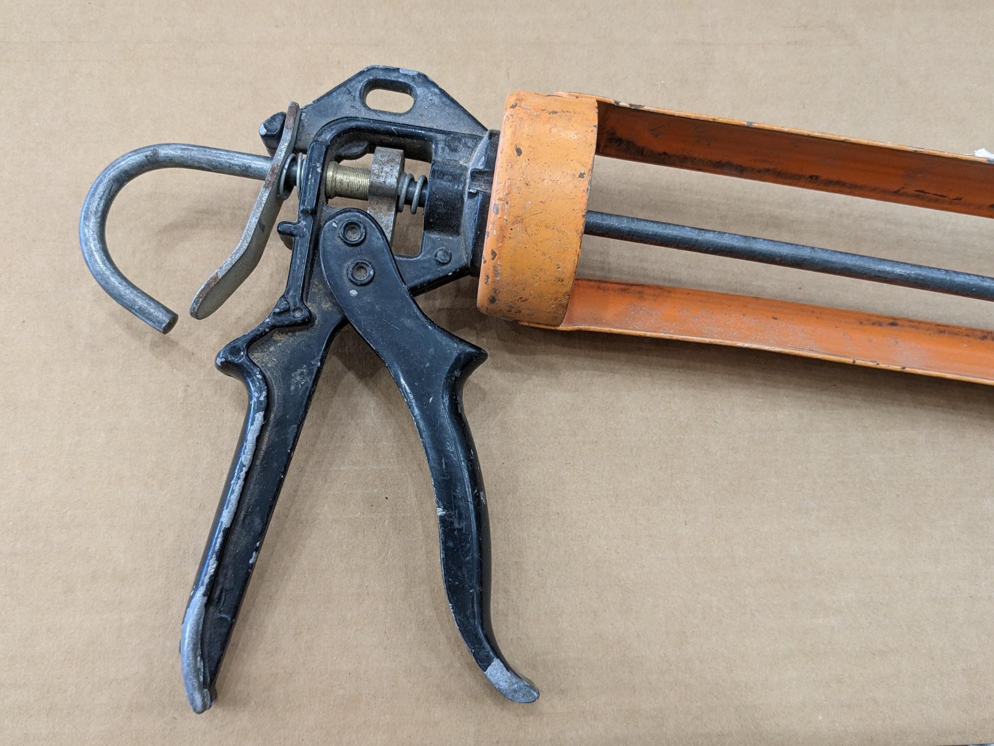 Two swiveling case caulk guns, one takes regular size tubes, other takes large. Both appear in good