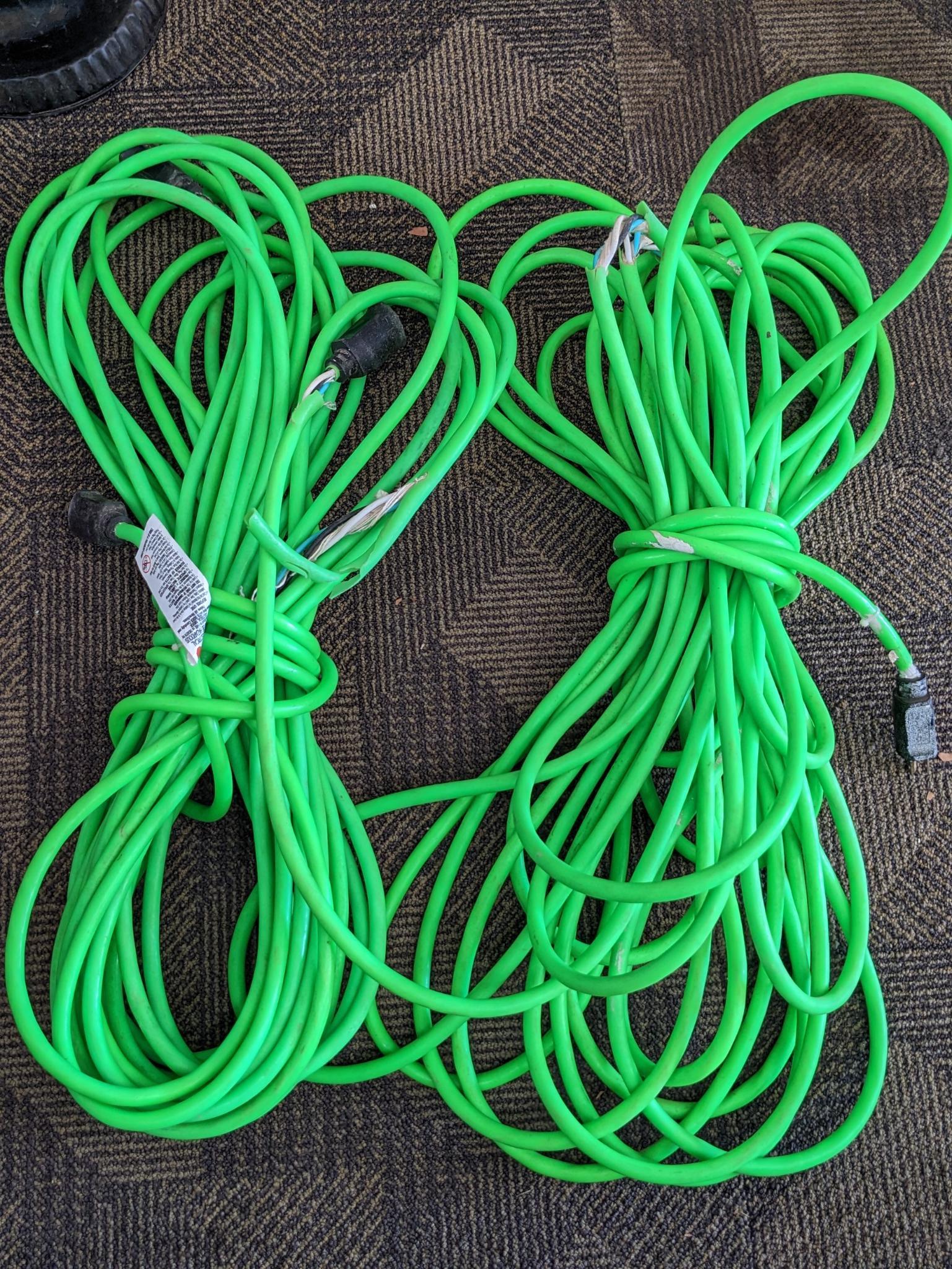 Two contractor extension cords. Notable tearing in outer insulation noted.