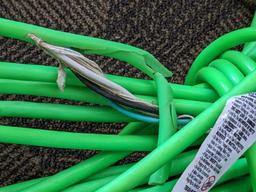 Two contractor extension cords. Notable tearing in outer insulation noted.