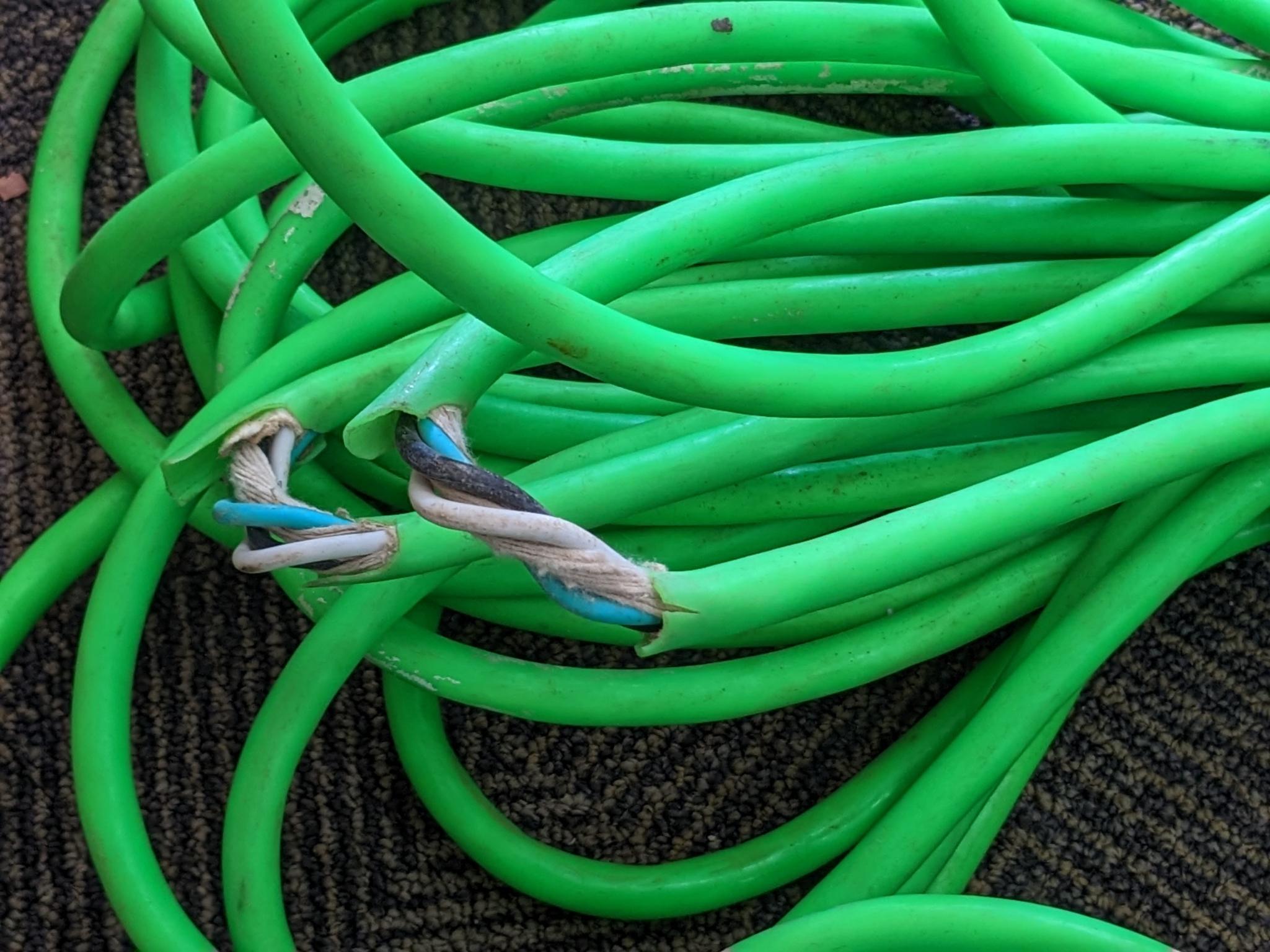 Two contractor extension cords. Notable tearing in outer insulation noted.