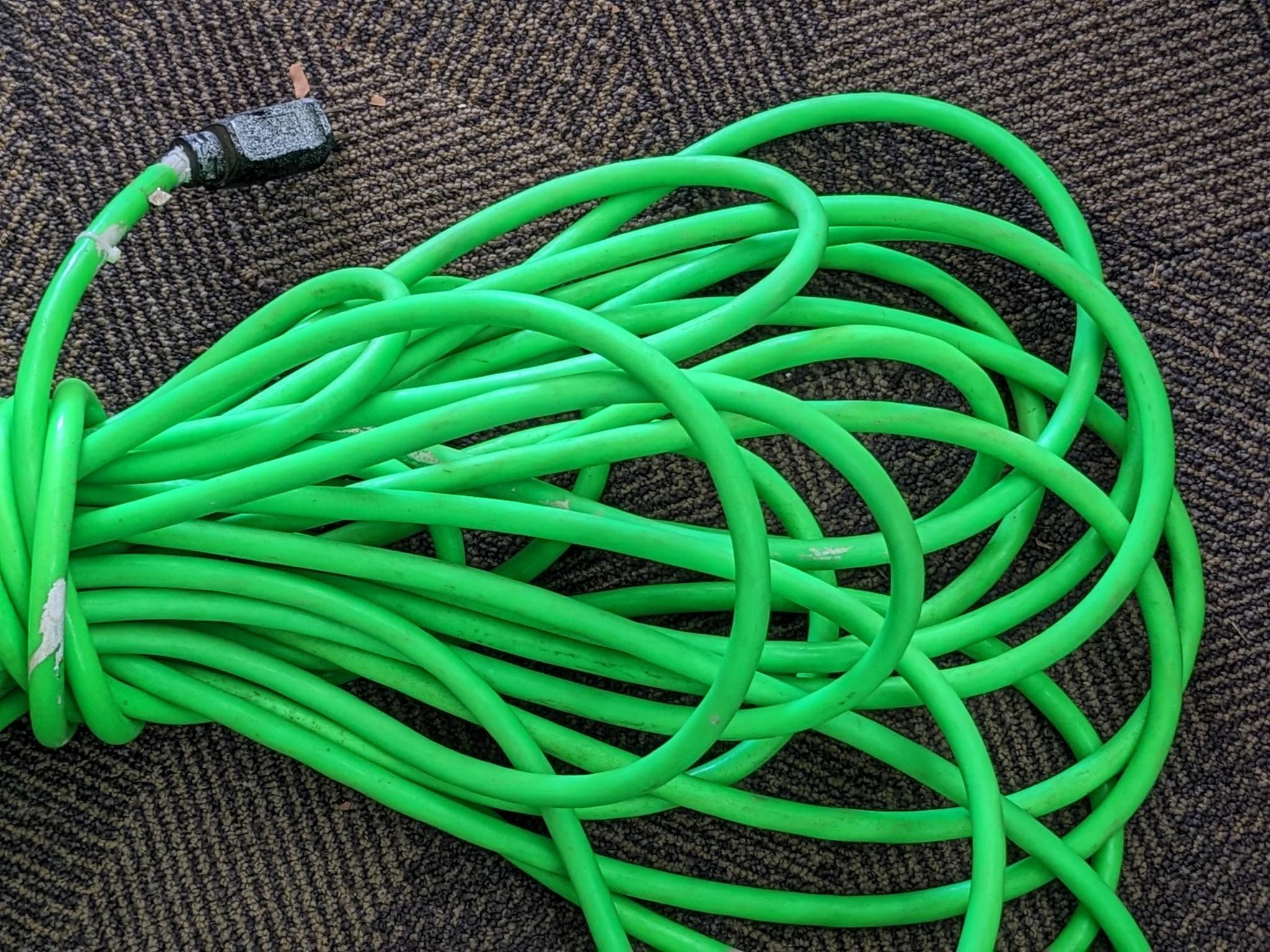 Two contractor extension cords. Notable tearing in outer insulation noted.