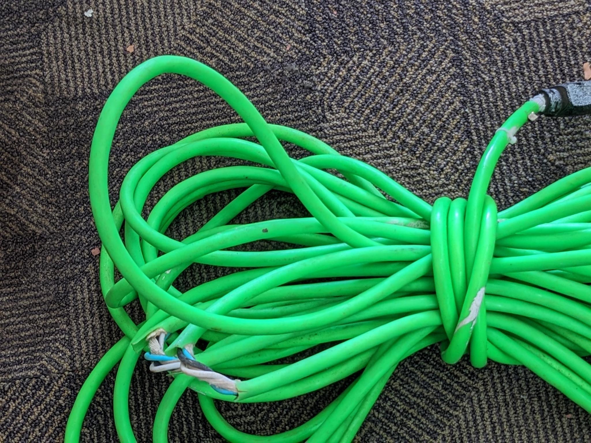 Two contractor extension cords. Notable tearing in outer insulation noted.