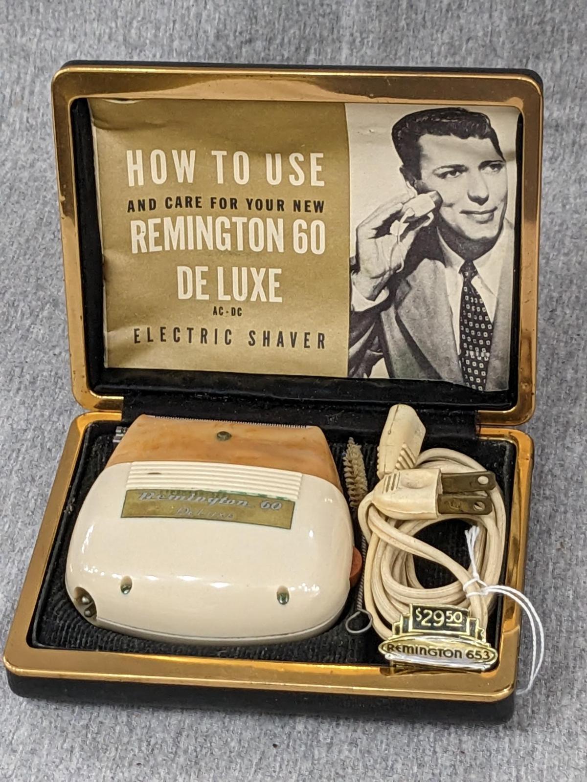 Remington 60 Deluxe electric shaver in original case; shaver measures 3" x 2-3/4".