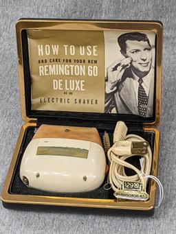 Remington 60 Deluxe electric shaver in original case; shaver measures 3" x 2-3/4".