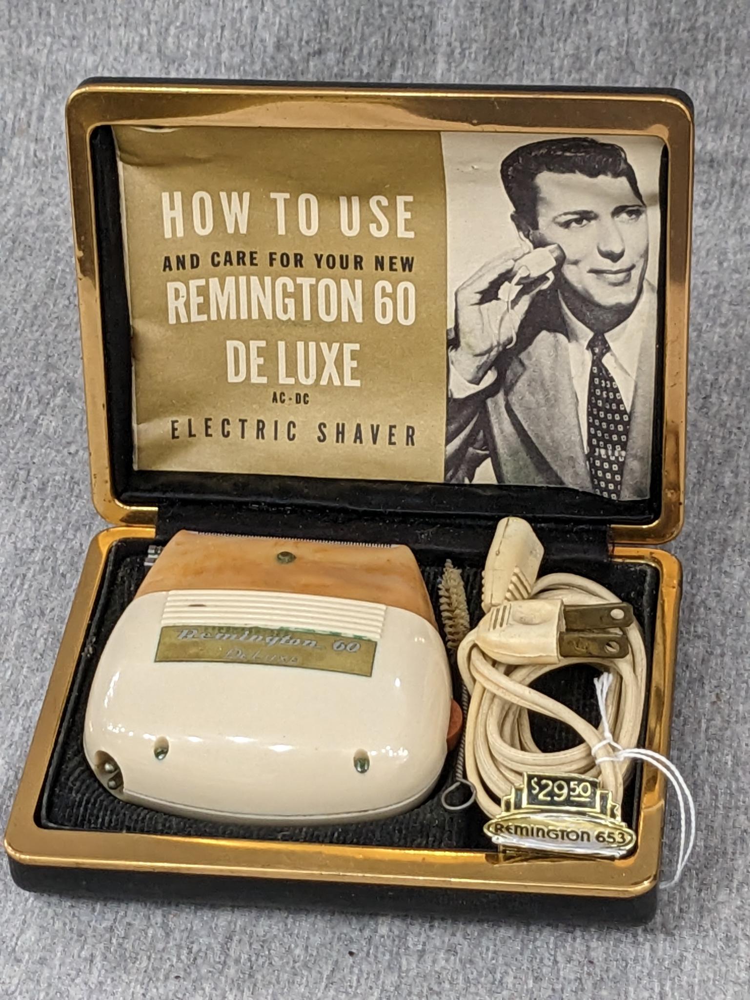 Remington 60 Deluxe electric shaver in original case; shaver measures 3" x 2-3/4".