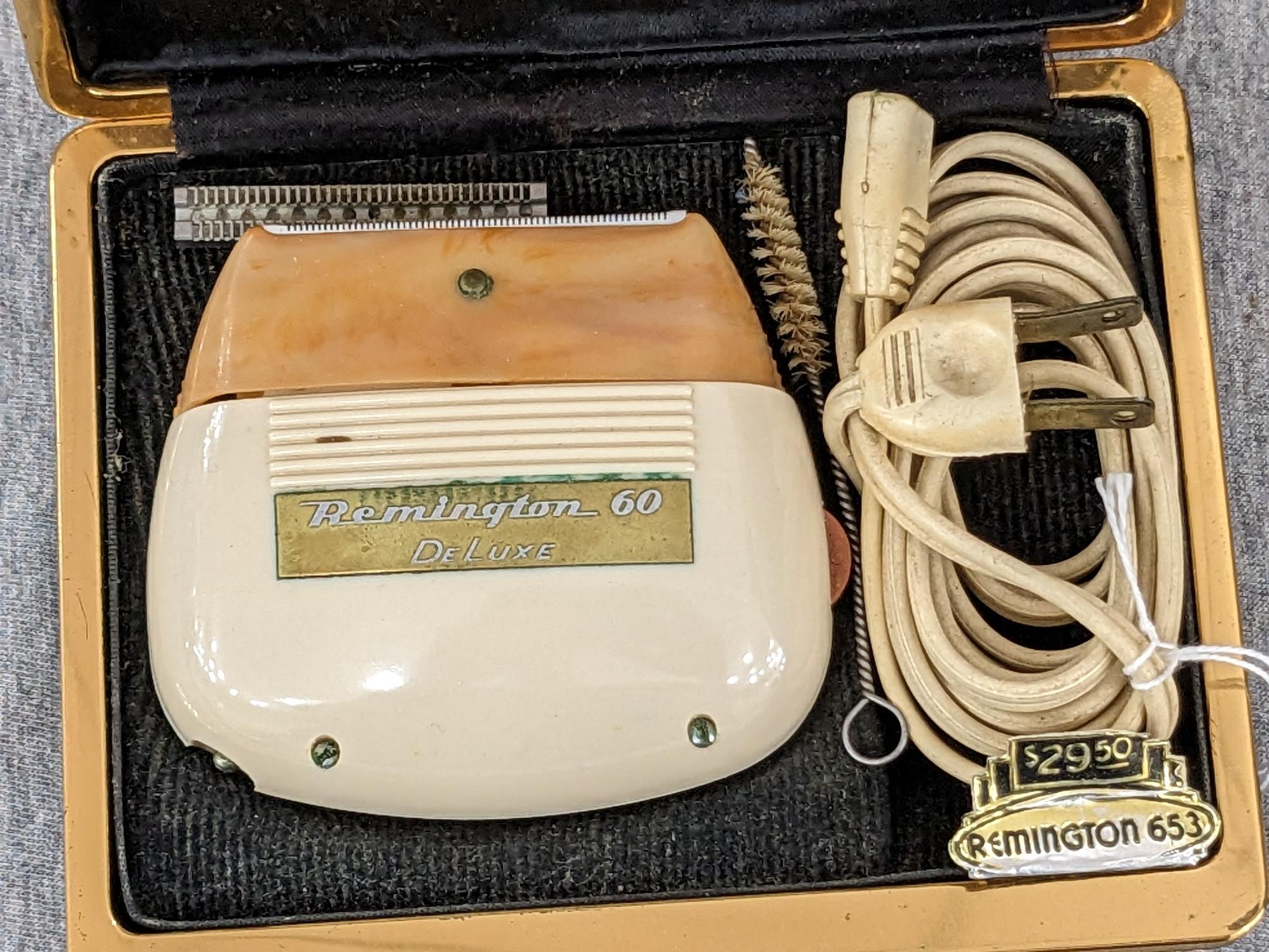Remington 60 Deluxe electric shaver in original case; shaver measures 3" x 2-3/4".