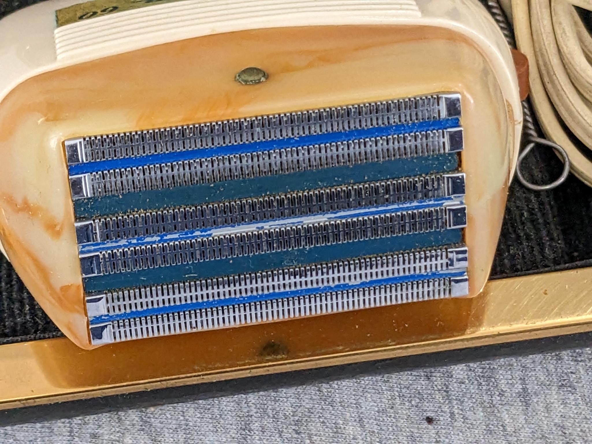 Remington 60 Deluxe electric shaver in original case; shaver measures 3" x 2-3/4".