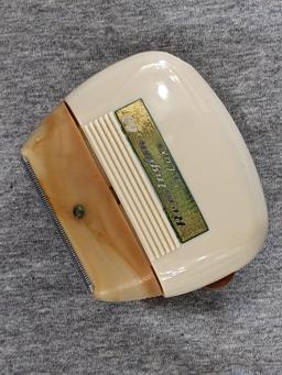 Remington 60 Deluxe electric shaver in original case; shaver measures 3" x 2-3/4".