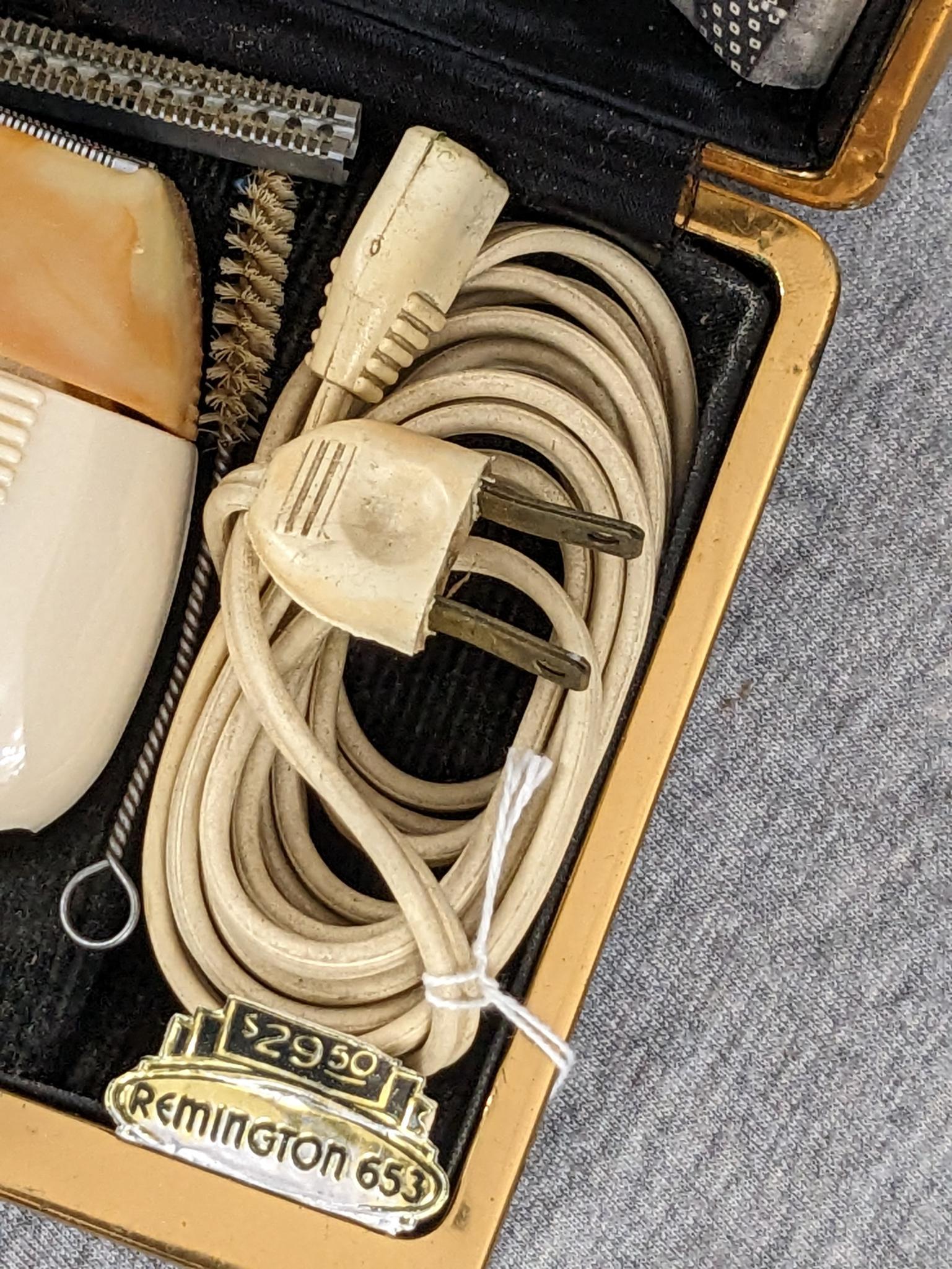 Remington 60 Deluxe electric shaver in original case; shaver measures 3" x 2-3/4".