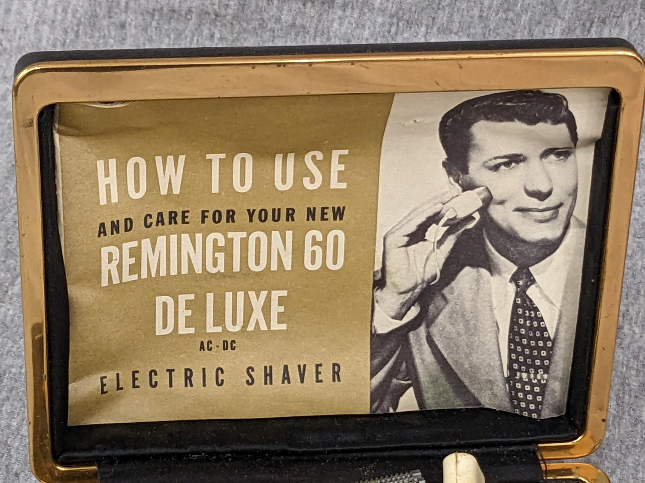 Remington 60 Deluxe electric shaver in original case; shaver measures 3" x 2-3/4".
