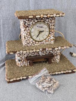 Interesting clock made with shells; measures 12" x 6-1/2" x 10-1/2" tall. Seller states it works and