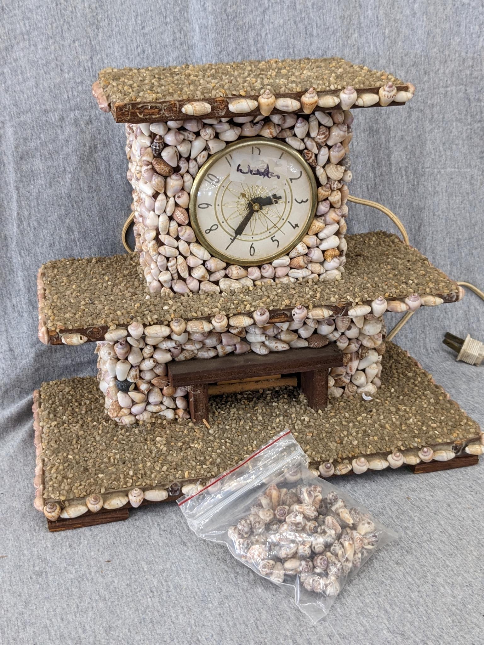 Interesting clock made with shells; measures 12" x 6-1/2" x 10-1/2" tall. Seller states it works and