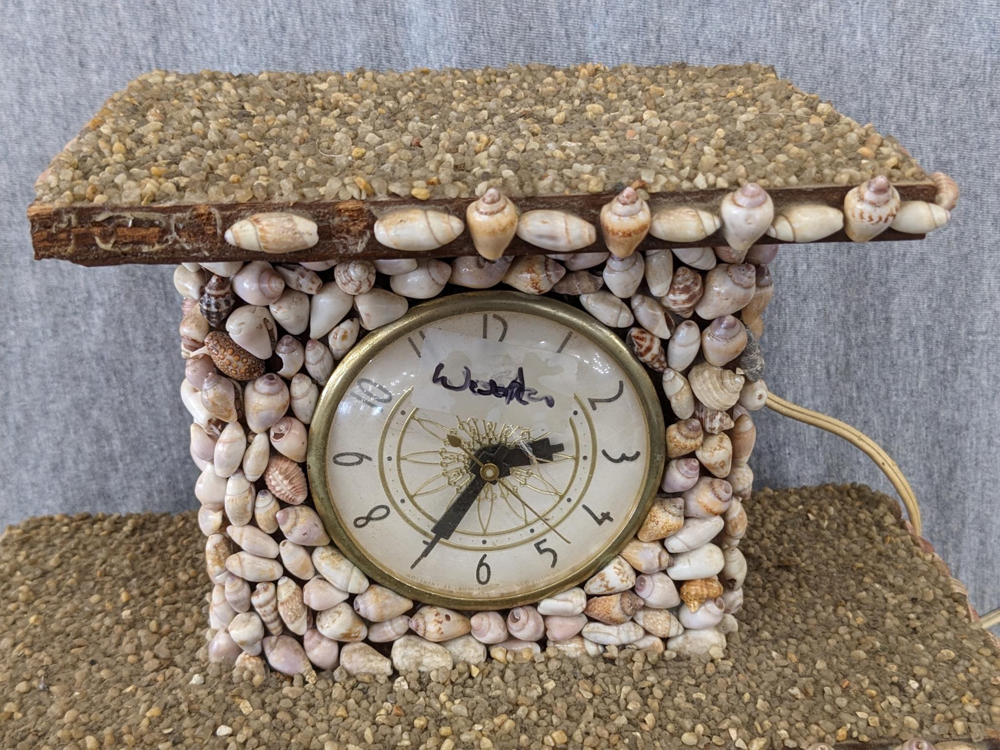 Interesting clock made with shells; measures 12" x 6-1/2" x 10-1/2" tall. Seller states it works and