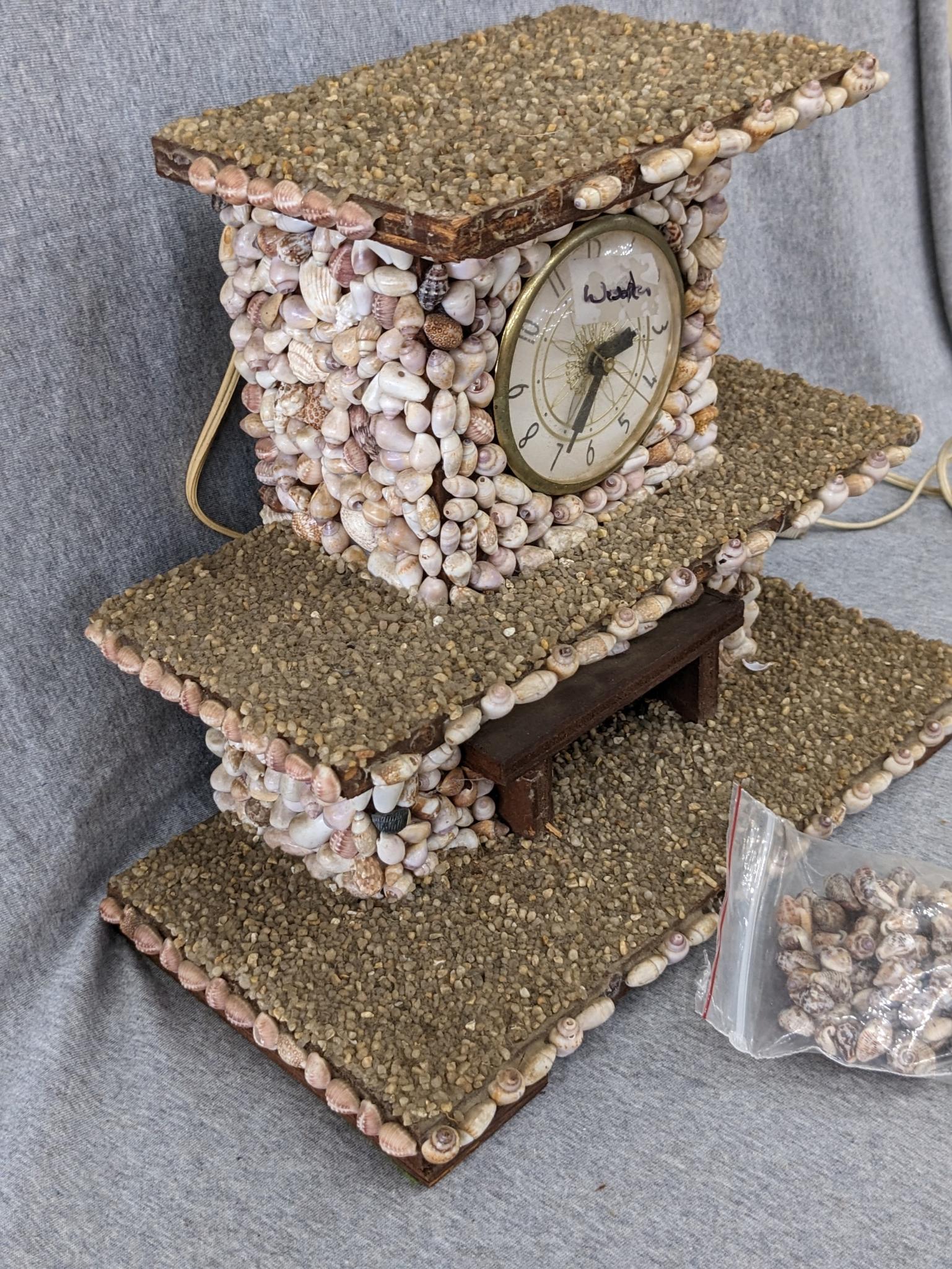 Interesting clock made with shells; measures 12" x 6-1/2" x 10-1/2" tall. Seller states it works and