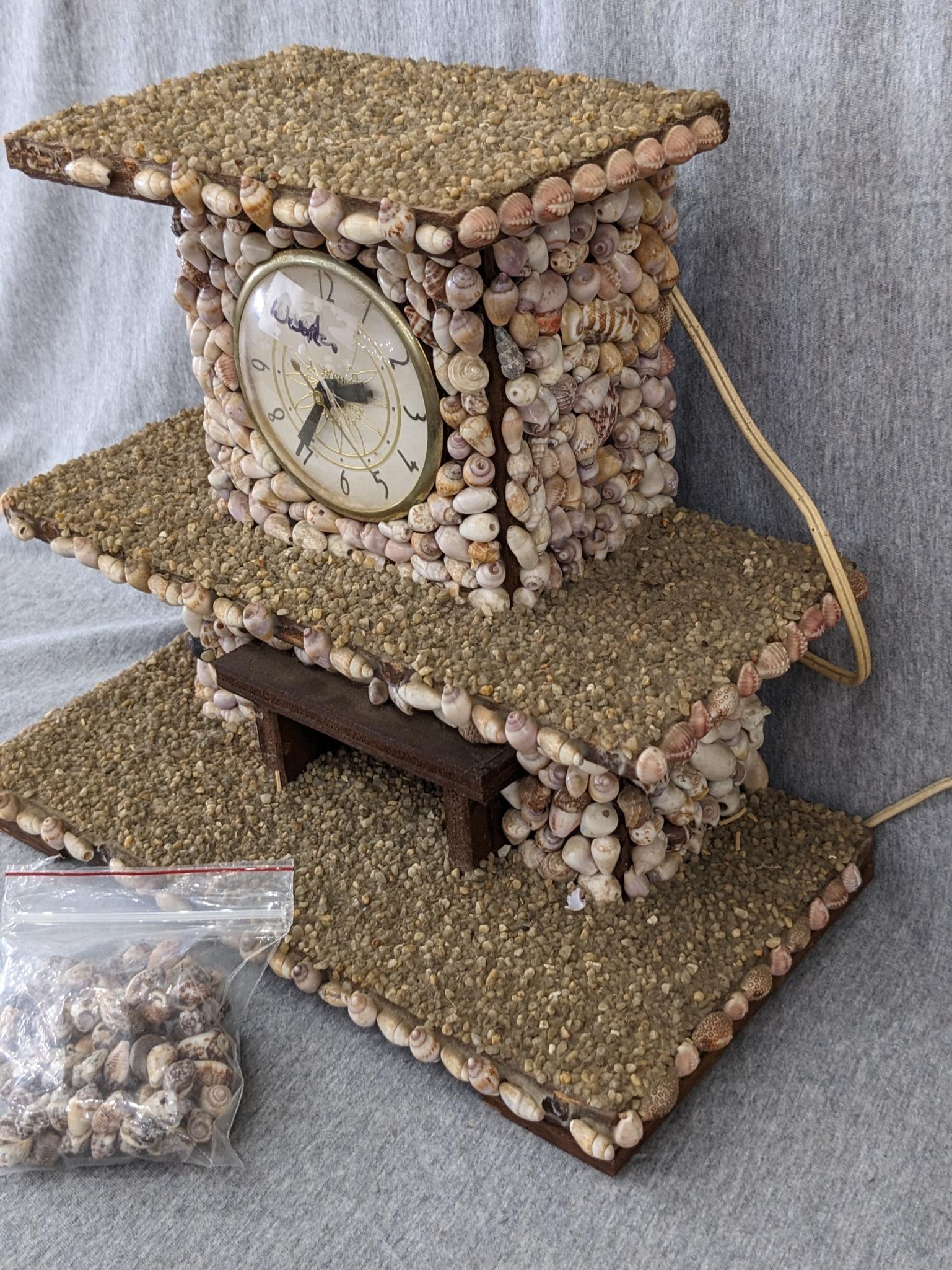 Interesting clock made with shells; measures 12" x 6-1/2" x 10-1/2" tall. Seller states it works and