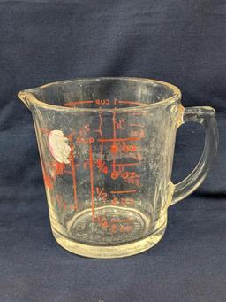 Set of 2 Fire King glass measuring cups include a 1 cup and 2 cup; larger measures 5" tall.